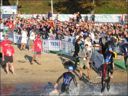 Athletes leaving the water for the second swim lap
